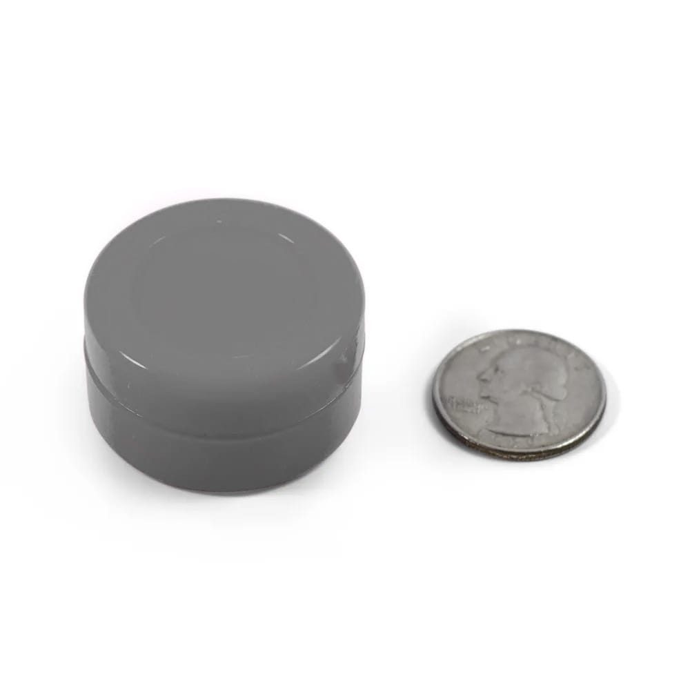 gray silicone puck with quarter to show size