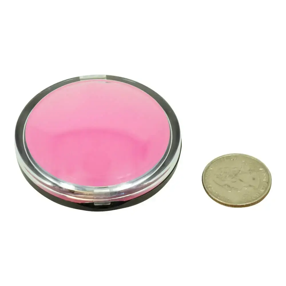 pink clamshell puck with coin to show size